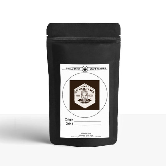 A black resealable stand-up pouch featuring a front label showcasing the "Silverhawk Coffee" logo, with "Original Roast" and "Grind" detailed underneath. The top text reads "Small Batch" and "Craft Roasted." This product is identified as a 12 Pack of Single Serve Coffee Capsules.